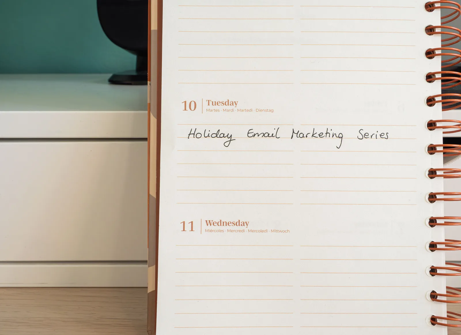 Planner open on a desk with handwritten 'Holiday Email Marketing Series' note. Email marketing templates sections: the permission record