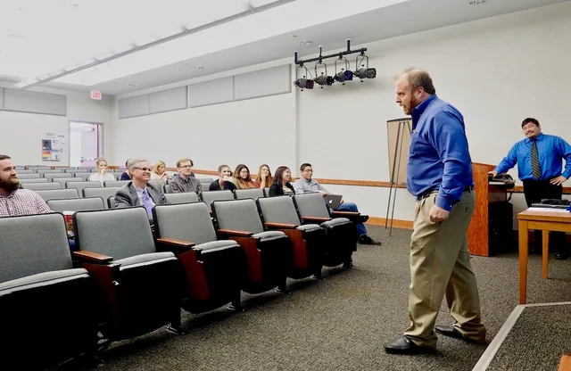 Germanna Community College's Marketing 100 instructor Neil Mairs (right, Associate Professor of Business) talks to his students and guests at his class' marketing plan case study presentations for the Charlottesville (Va.)-based Hospice of the Piedmont on Tuesday, December 5, 2017 at the Fredericksb. Marketing Case Study Sections in Plain Terms