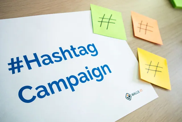 An organized workspace with hashtag campaign materials and colorful sticky notes. Which Marketing Plan Template Examples to Copy